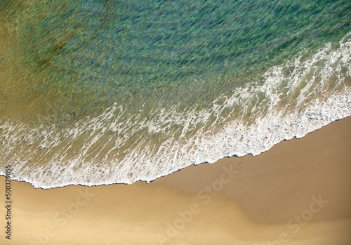 Waves in the ocean. Turquoise sea waves. Beautiful sea waves with foam of blue and turquoise color.