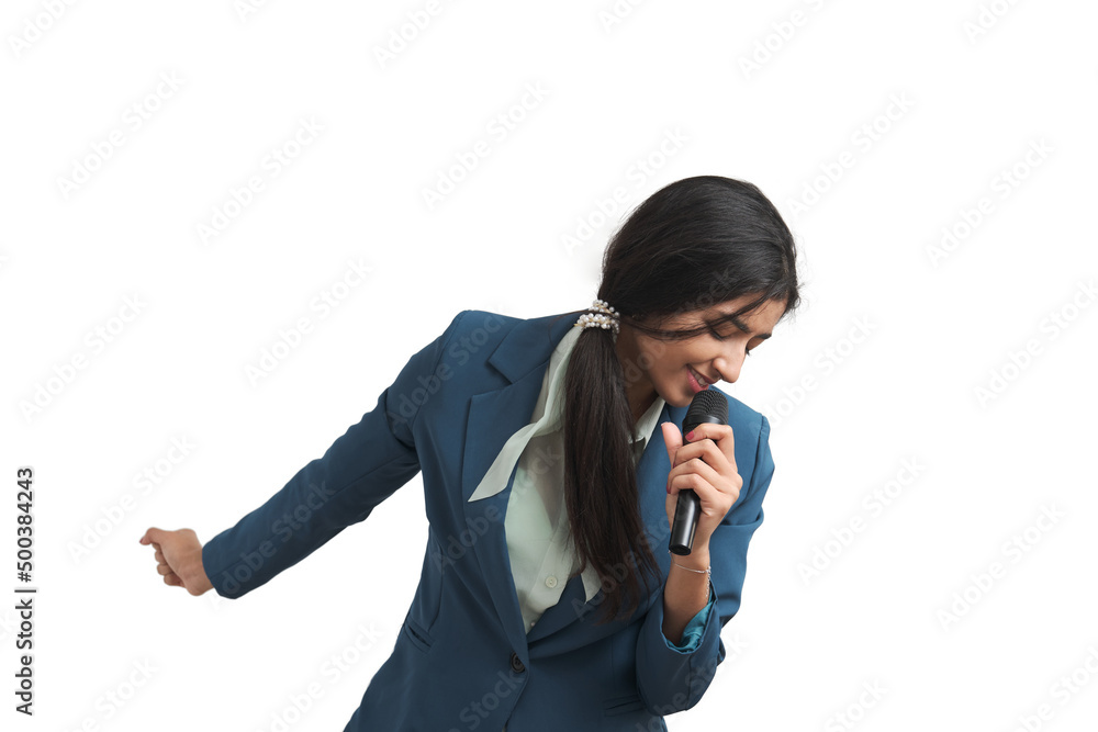 Young Venezuelan woman singing with a microphone, isolated. Young Venezuelan woman singing with a microphone, isolated.