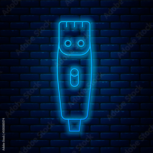 Glowing neon line Electrical hair clipper or shaver icon isolated on brick wall background. Barbershop symbol. Vector