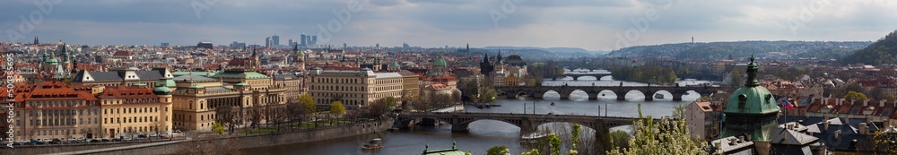 Panorama of Prague, the old town the river. Panorama of Prague in the sun. The castle district, the Vltava river (Moldau) the Charles bridge and the historic district of the city center.
