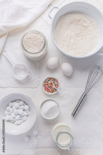 Baking background with flour, eggs, sugar sprinkles, kitchen tools, utensils