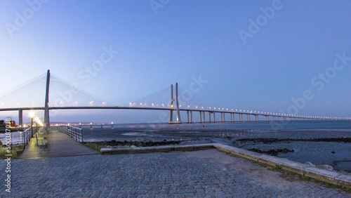Vasco da Gama Bridge over the tagus river timelapse, Lisbon, Portugal photo