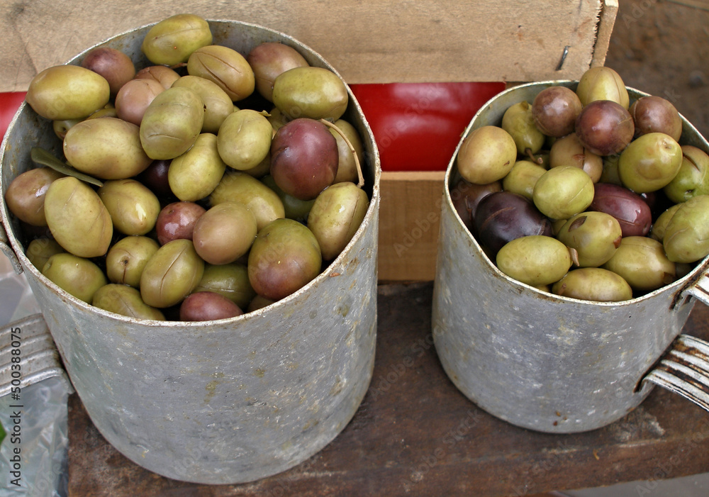 Pickled olives in a traditional tin cup 
