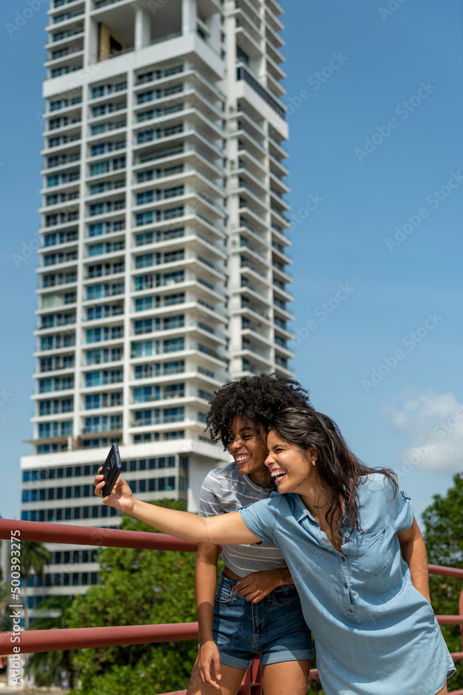 Portrait of two latin woman friends taking selfie in Panama city, Panama