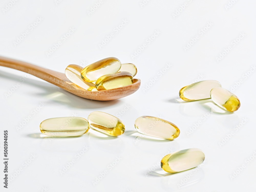 Closeup of an omega-3 oil capsule on a table Closeup of an omega-3 oil capsule on a table