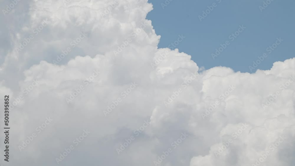Sky cloud cotton blue clouds beautiful background outdoor moving cloud cluster swirling upward time-lapse . Cloud moving and transforming fast in the clear blue sky . Time lapse cloud beautiful sky Sky cloud cotton blue clouds beautiful background outdoor moving cloud cluster swirling upward time-lapse . Cloud moving and transforming fast in the clear blue sky . Time lapse cloud beautiful sky