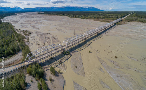Aerial view of the Alaska Highway crossing the silt and mud loaded Tanana river  photo