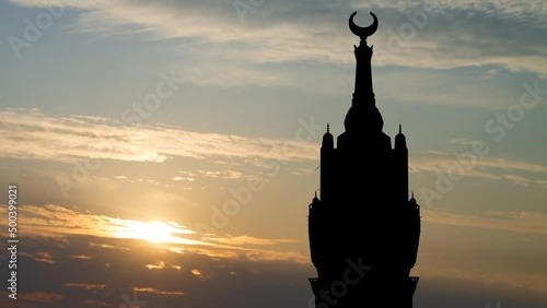 Mecca Clock Tower Silhouette: Time Lapse at Sunrise with Red Light, Saudi Arabia photo