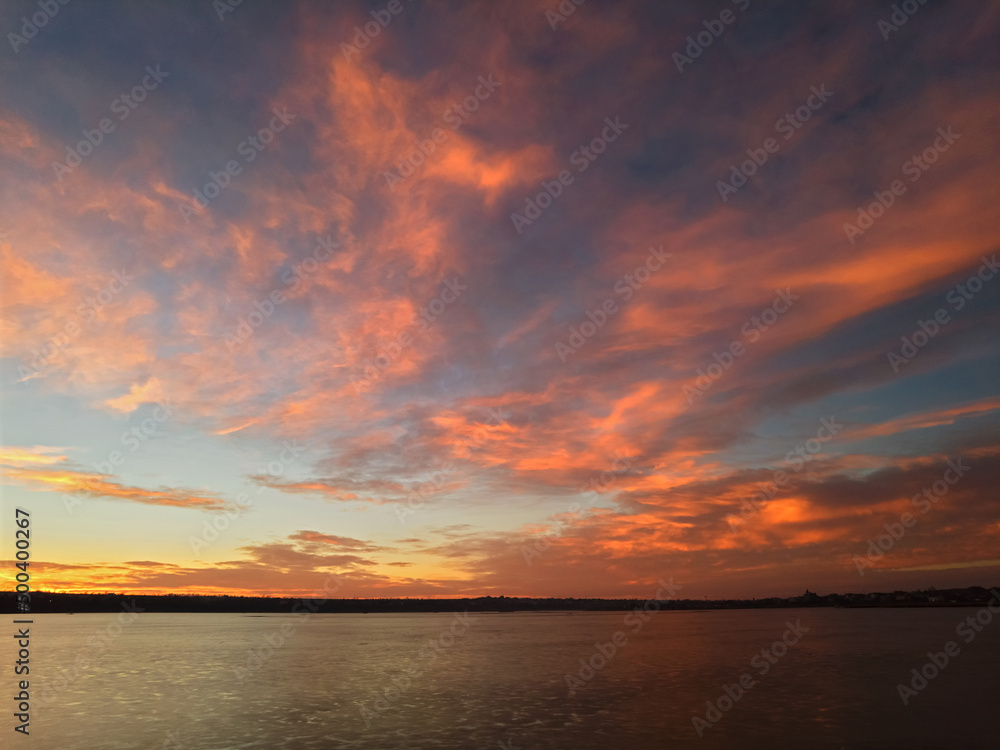 Sunrise over the lake, with red-orange clouds