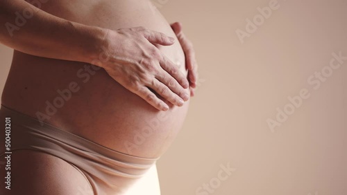Wallpaper Mural pregnant woman. health pregnancy motherhood procreation concept. close-up belly of a pregnant sunlight woman. woman waiting for a newborn baby. pregnant woman holding her belly indoors Torontodigital.ca