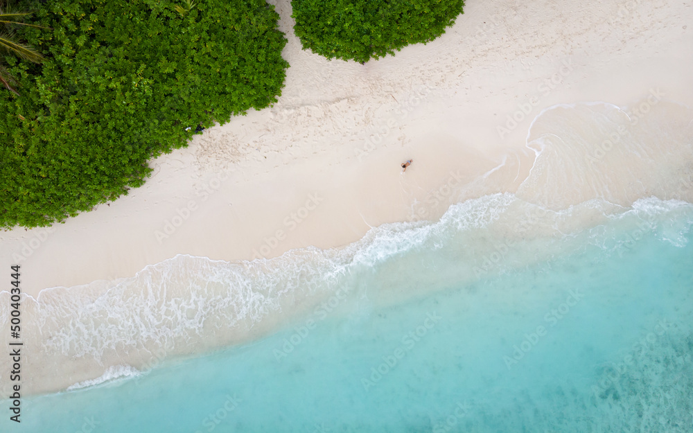 Aerial top view from drone of beach with turquoise sea waves with copy space for text