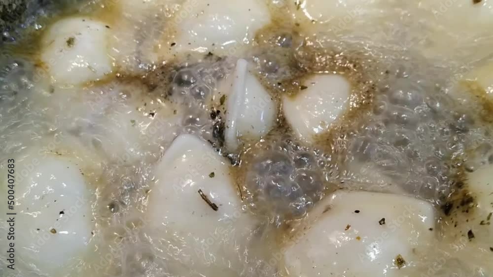 cooking dumplings in a saucepan closeup video. cooking dumplings in a saucepan closeup video.