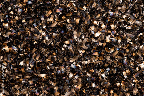 black pieces of metal and steel filings photographed in close-up macro in a metal factory