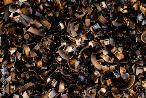 black pieces of metal and steel filings photographed in close-up macro in a metal factory
