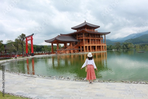 Photography The asian woman enjoyed with the great wooden building veiw.