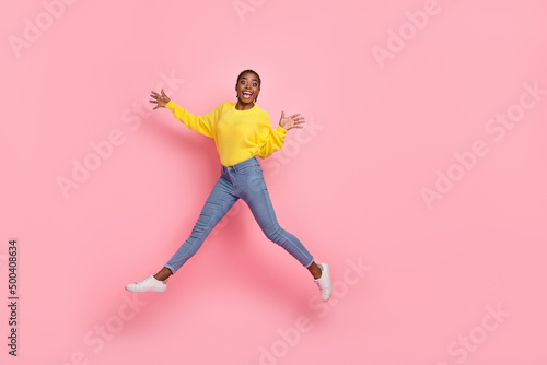 Full size profile side photo of young lovely excited girl have fun jump walk isolated over pink color background