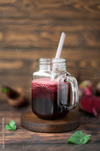 vegetable smoothie with spinach and beets in a glass mug, close-up