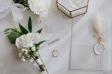 Brides wedding accesories, ring, bouquets and invitation card on flat lay wedding day