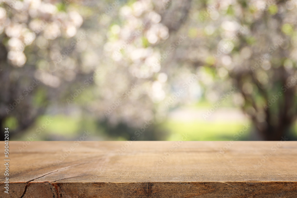 wooden table in front of spring blossom tree landscape. Product display and presentation wooden table in front of spring blossom tree landscape. Product display and presentation