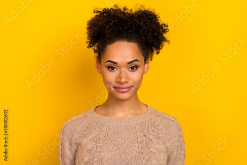 Photo of adorable pretty young woman wear beige sweater smiling isolated yellow color background © deagreez