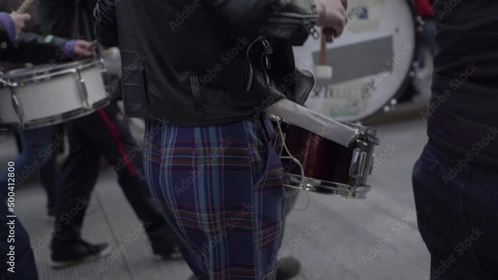A woman is playing drums while marching during a protest in the International Women's day in Quito, Ecuador. Other people on the back are also carrying and playing drums. #8M A woman is playing drums while marching during a protest in the International Women's day in Quito, Ecuador. Other people on the back are also carrying and playing drums. #8M