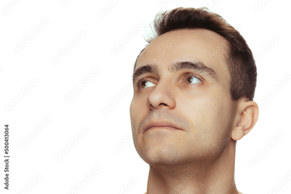 Obraz premium Close-up portrait of young handsome man with clean face, perfect skin, shirtless posing isolated over white studio background