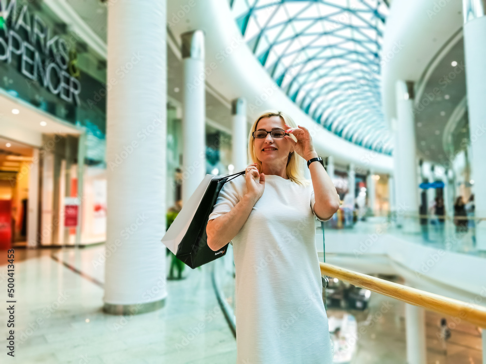 Fototapeta premium Positive emotions. Lifestyle concept. Close up of young charming caucasian woman in white dress smiling