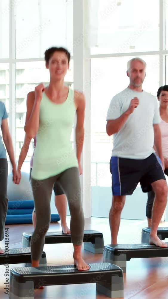 Aerobics class stepping together Aerobics class stepping together