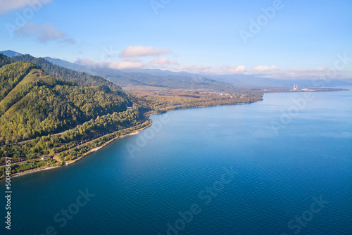 Beautiful summer landscape from the air. Mountains, forest, road along the shore of Lake Baikal