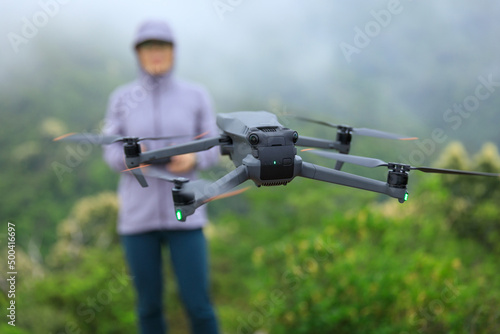 Flying drone in spring forest