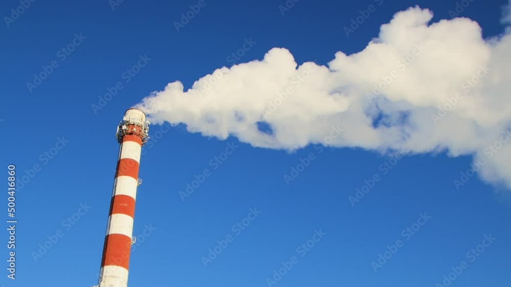 White smoke from the chimney moves horizontally sideways like a fluffy cloud. A modern industrial area on the outskirts of the city's city. Summer time lapse, blue sky, warm light, panorama. UHD 4K. White smoke from the chimney moves horizontally sideways like a fluffy cloud. A modern industrial area on the outskirts of the city's city. Summer time lapse, blue sky, warm light, panorama. UHD 4K.
