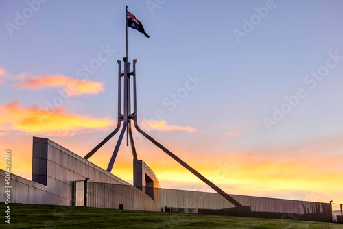 Australian Parliament House Canberra Australian Capital Territory. Showing the roof at sunset and the Australian Flag photo