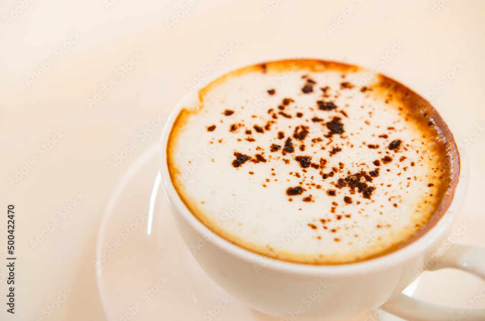 Obraz premium Cappuccino coffee on white table, photo taken in studio. Soft focus