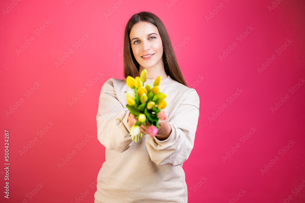 Happy young woman enjoy bouquet of tulips on pink background. Happy young woman enjoy bouquet of tulips on pink background.