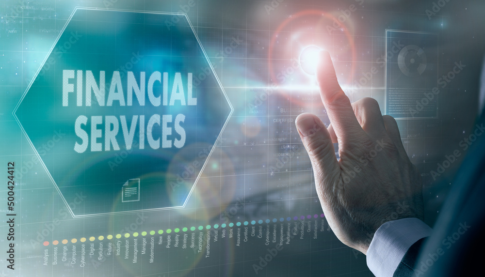 A businessman controlling a futuristic display with a Financial Services business concept on it.
