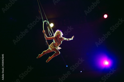 An aerial gymnast shows a performance in the circus arena. © davit85