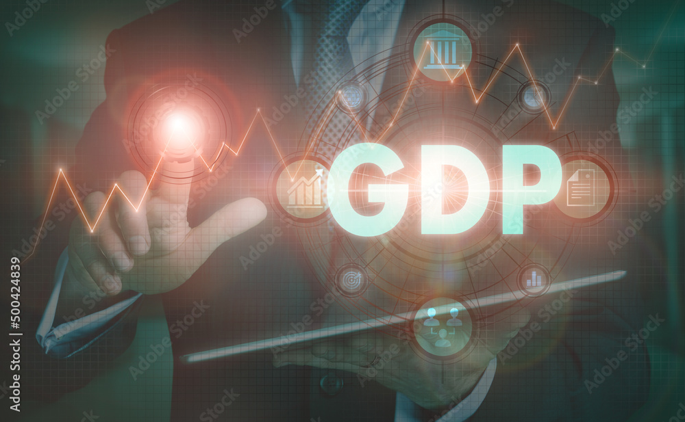 A businessman operating a computer display with a GDP business word concept on it.