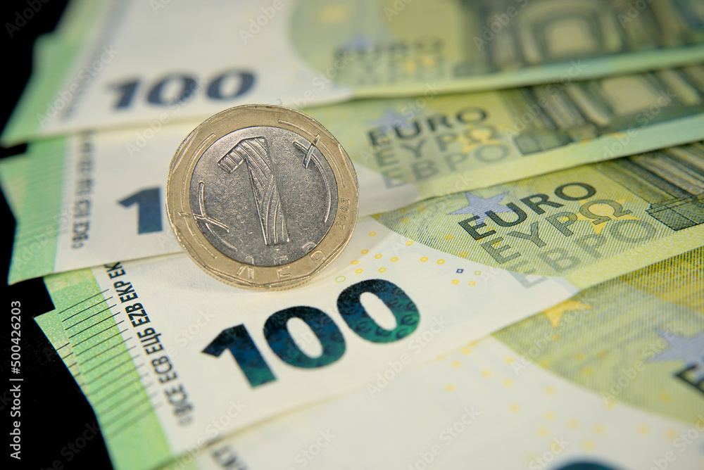 one hundred euro banknotes of the European Union, one Bulgarian lev macro photo one hundred euro banknotes of the European Union, one Bulgarian lev macro photo