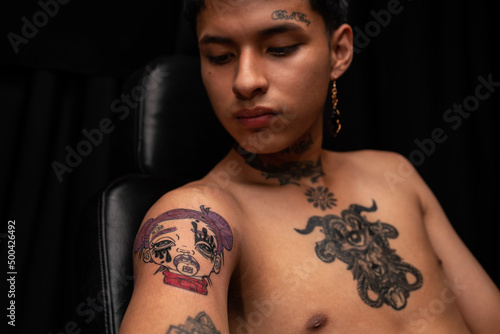 Peruvian shirtless man with tattoos on body photo