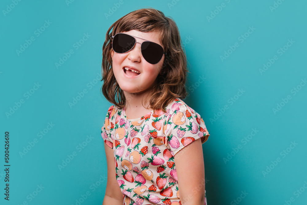 Girl in sunglasses standing in studio Girl in sunglasses standing in studio