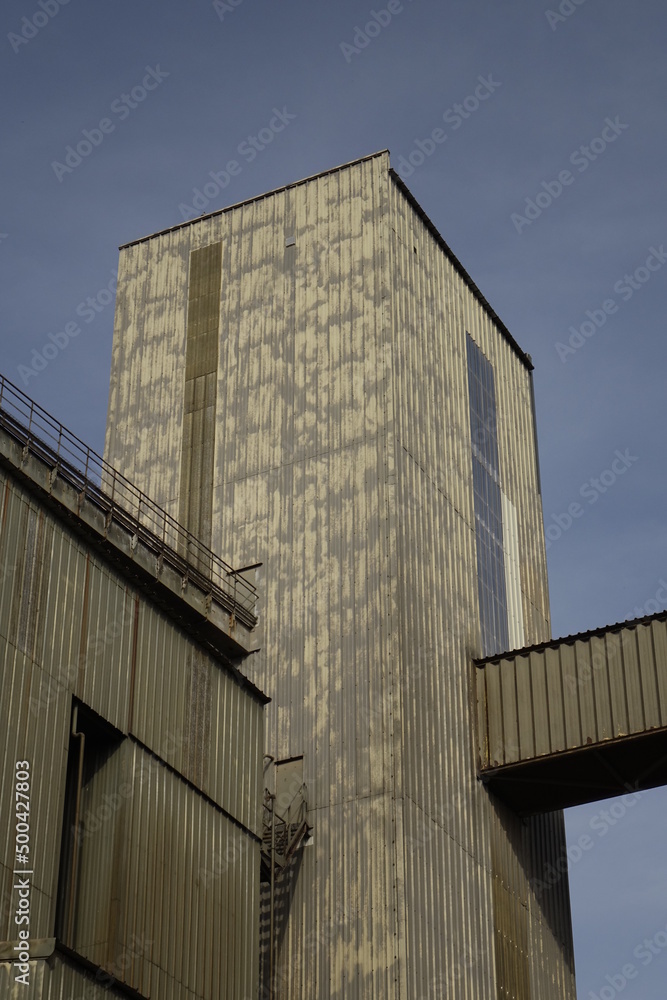 Factory building under blue spring sky, concept: industry, industrial (vertical), Seltz, Grand Est, France