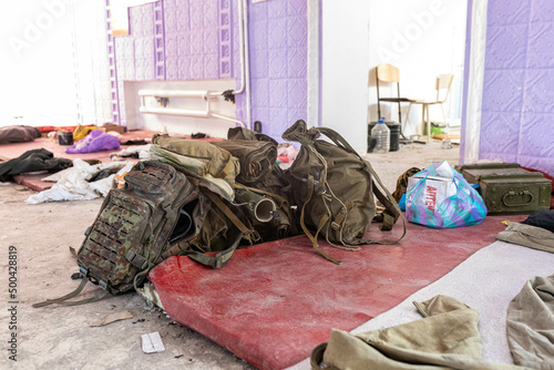  Dirt and trash, garbage and backpacks in the half-destroyed school hall after Russian invasion, they lived on the school mats and slept here. 