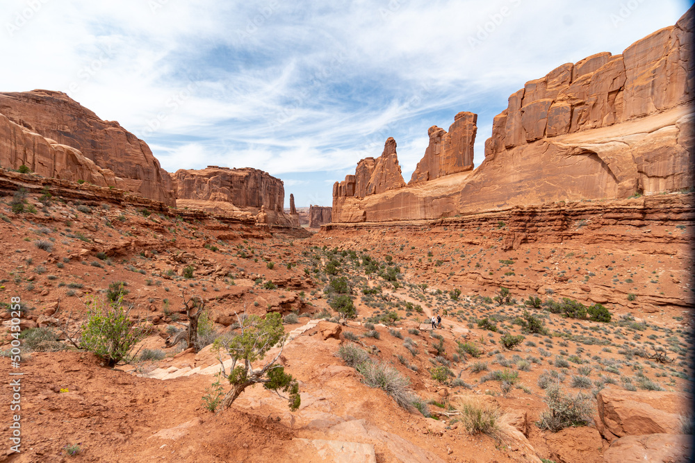 Arches National Park at Midday - Arches has many arches including the famous Delicate Arch, the Window Arch, the Double Arch and other features such as Tower of Babel, Turret Arch, and the Courthouse Arches National Park at Midday - Arches has many arches including the famous Delicate Arch, the Window Arch, the Double Arch and other features such as Tower of Babel, Turret Arch, and the Courthouse
