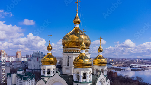 White stone temple with golden domes. Early spring. Russia. The Far East. Khabarovsk. 