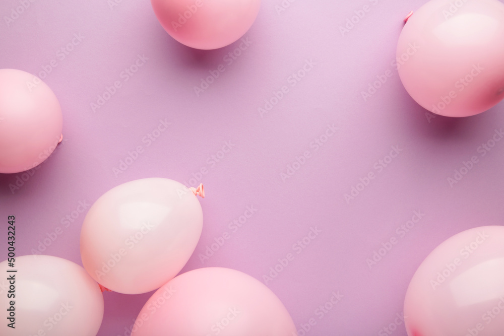 Birthday background with pink balloons on pink background, top view Birthday background with pink balloons on pink background, top view