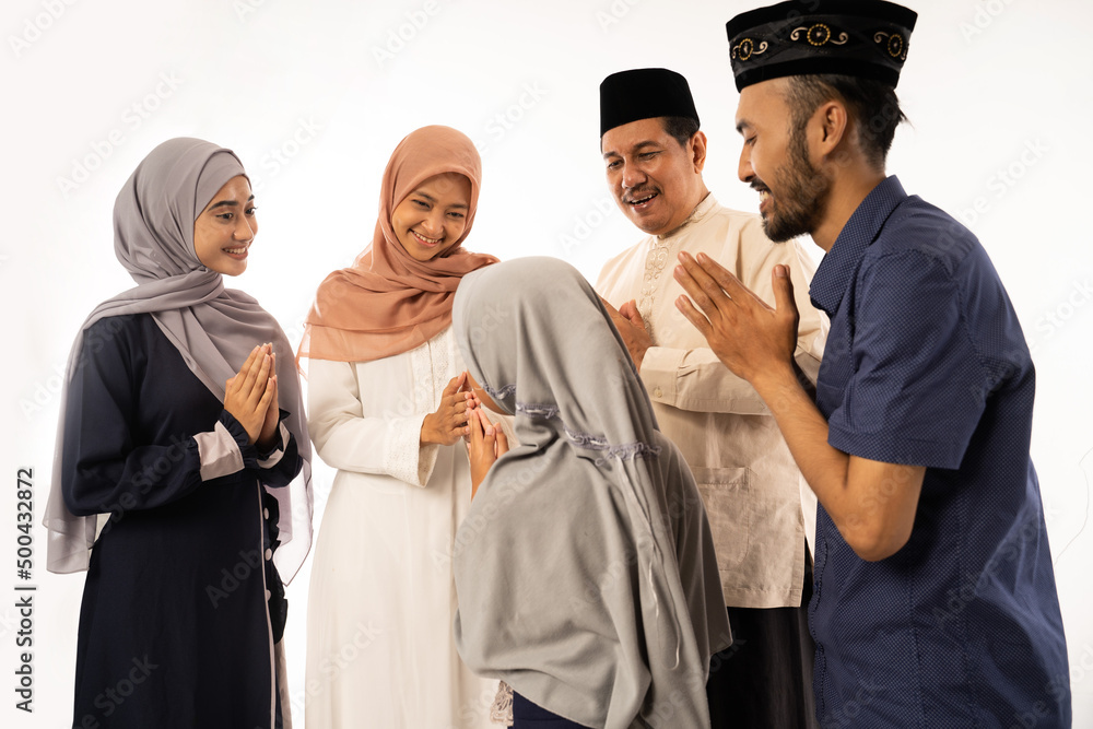beautiful asian muslim family shake hand on idul fitri celebration