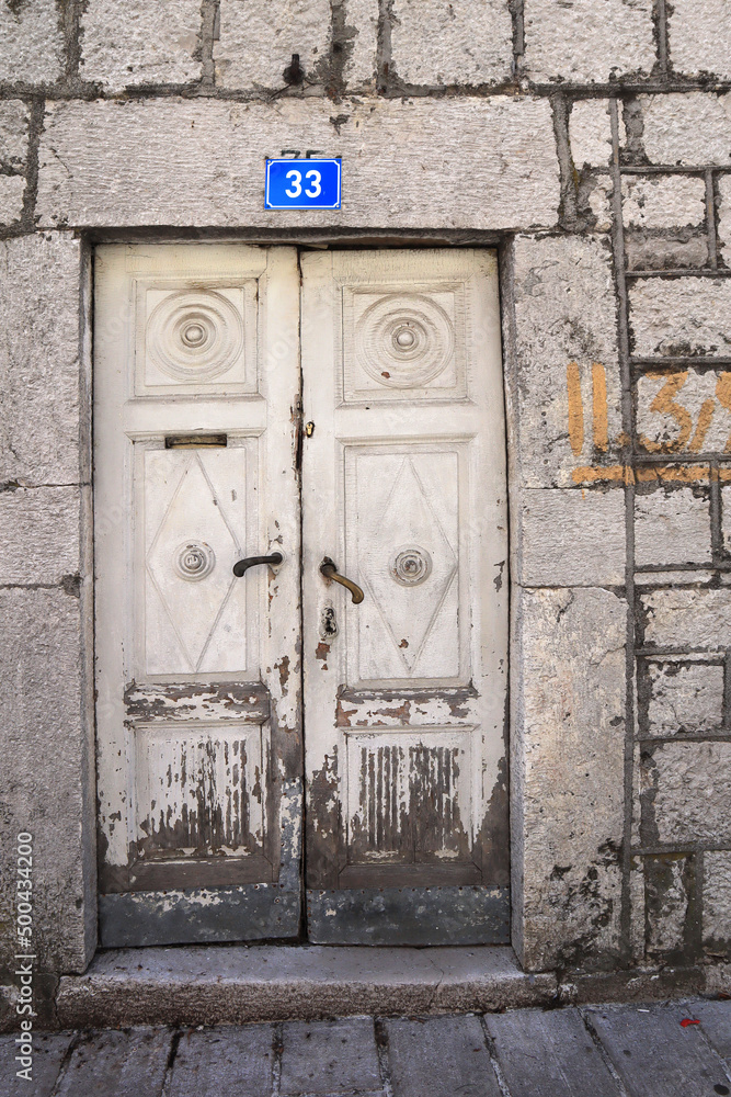Wooden door of stone house in Cetinje, Montenegro
