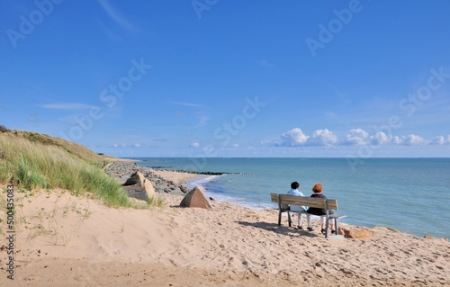 A couple is watching the sea at Noirmoutier in France
