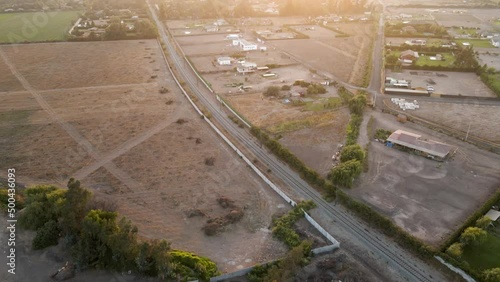 Dolly in aerial view of a railroad track in a rural area, Talagante, Chile. photo