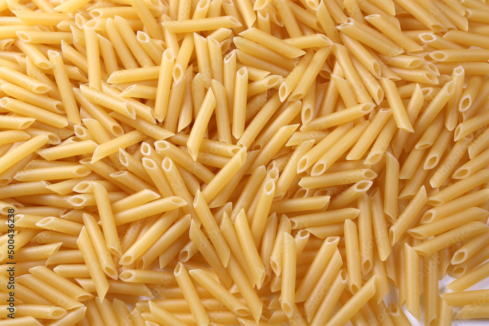 Penne pasta as background. Concept - healthy food. Penne pasta as background. Concept - healthy food.